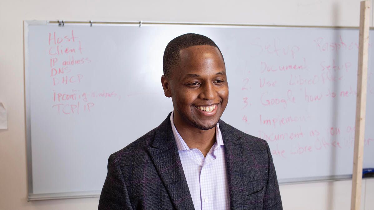 Benjamin Harvey, CEO of AI Squared, standing in front of a whiteboard. 