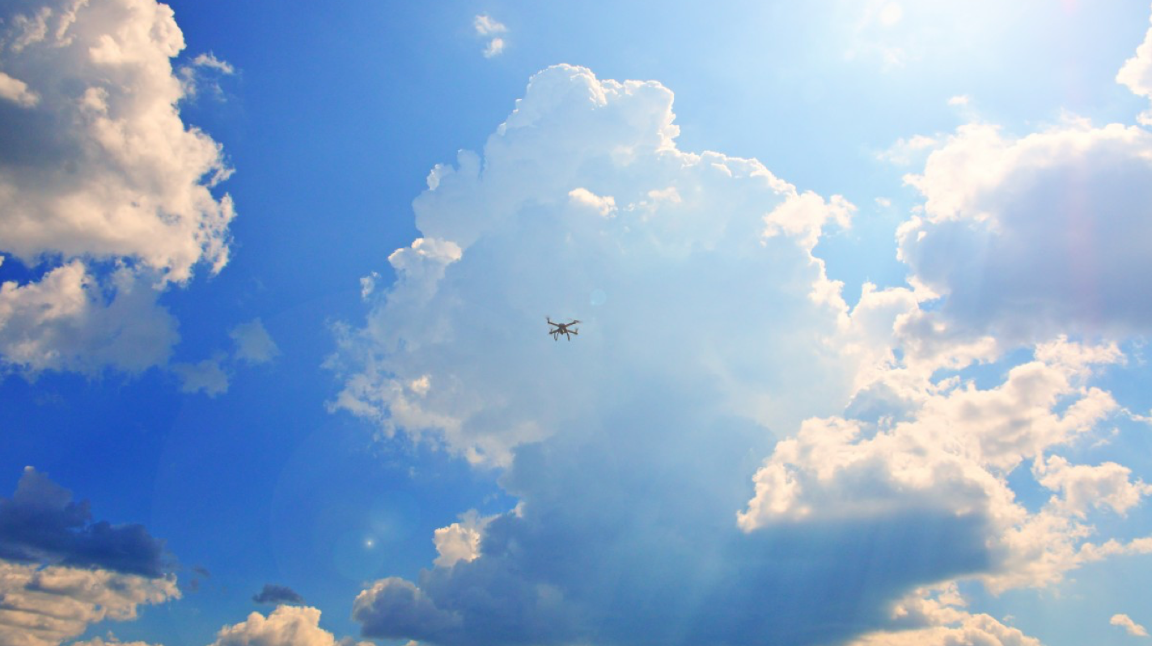 Drone flying over a blue sky