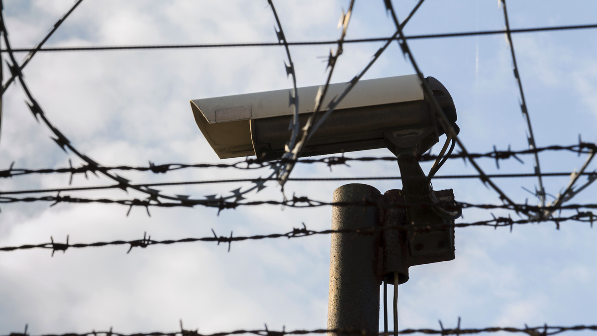 Security camera behind barbed wire