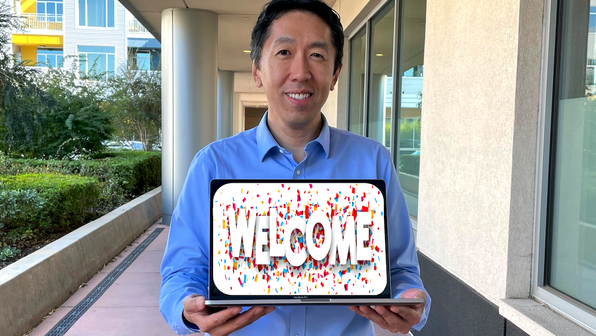 Andrew Ng with a welcome message displayed on a laptop
