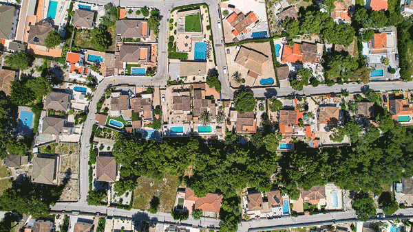 Satellite imagery of suburban homes with backyard pools. 