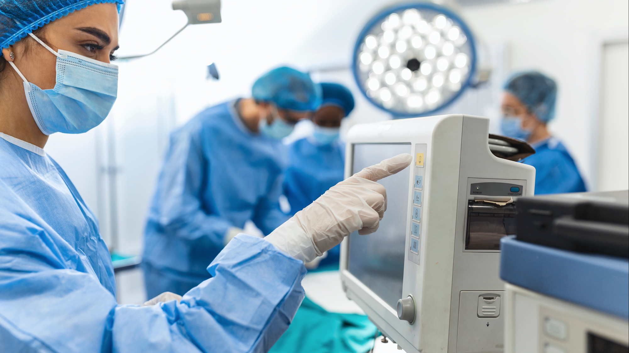 Doctor checking a monitor inside an OR