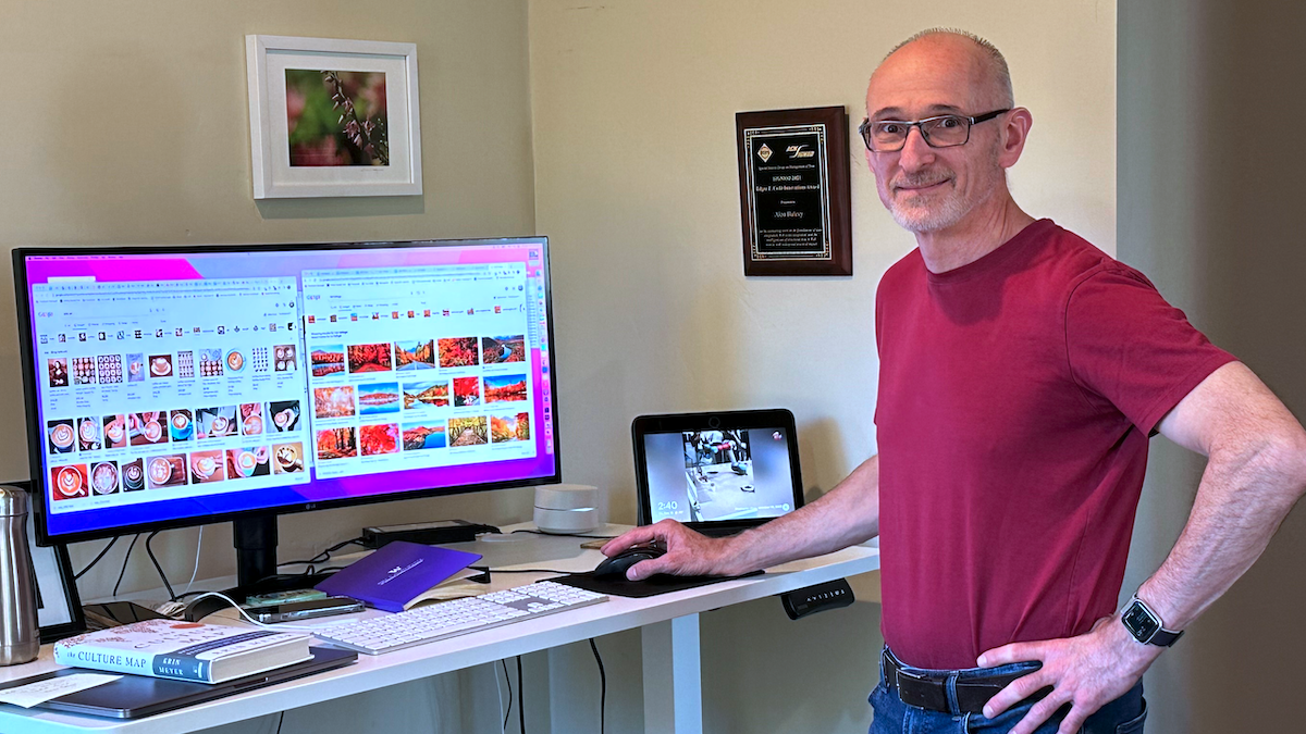 Alon Halevy next to a big computer monitor