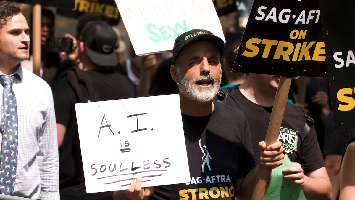 SAG-AFTRA member with a picket sign that says "A.I. is soulless"