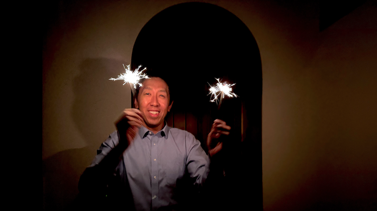 Andrew Ng celebrating and wishing a Happy New Year 2025 with sparklers.